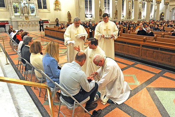 Bishop Richard J. Malone washes the feet of 12 parishioners at St. Joseph Cathedral during the Evening Mass of the Lord's Supper. (Dan Cappellazzo/Staff Photographer)